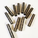 Set of 11 ebony wood knife rests with brass inlay