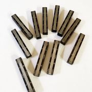 Set of 11 ebony wood knife rests with brass inlay