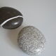 2 boxes in lithographed sheet metal in the shape of a pebble