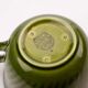 Set of 4 green porcelain cups and milk jug by Boch.