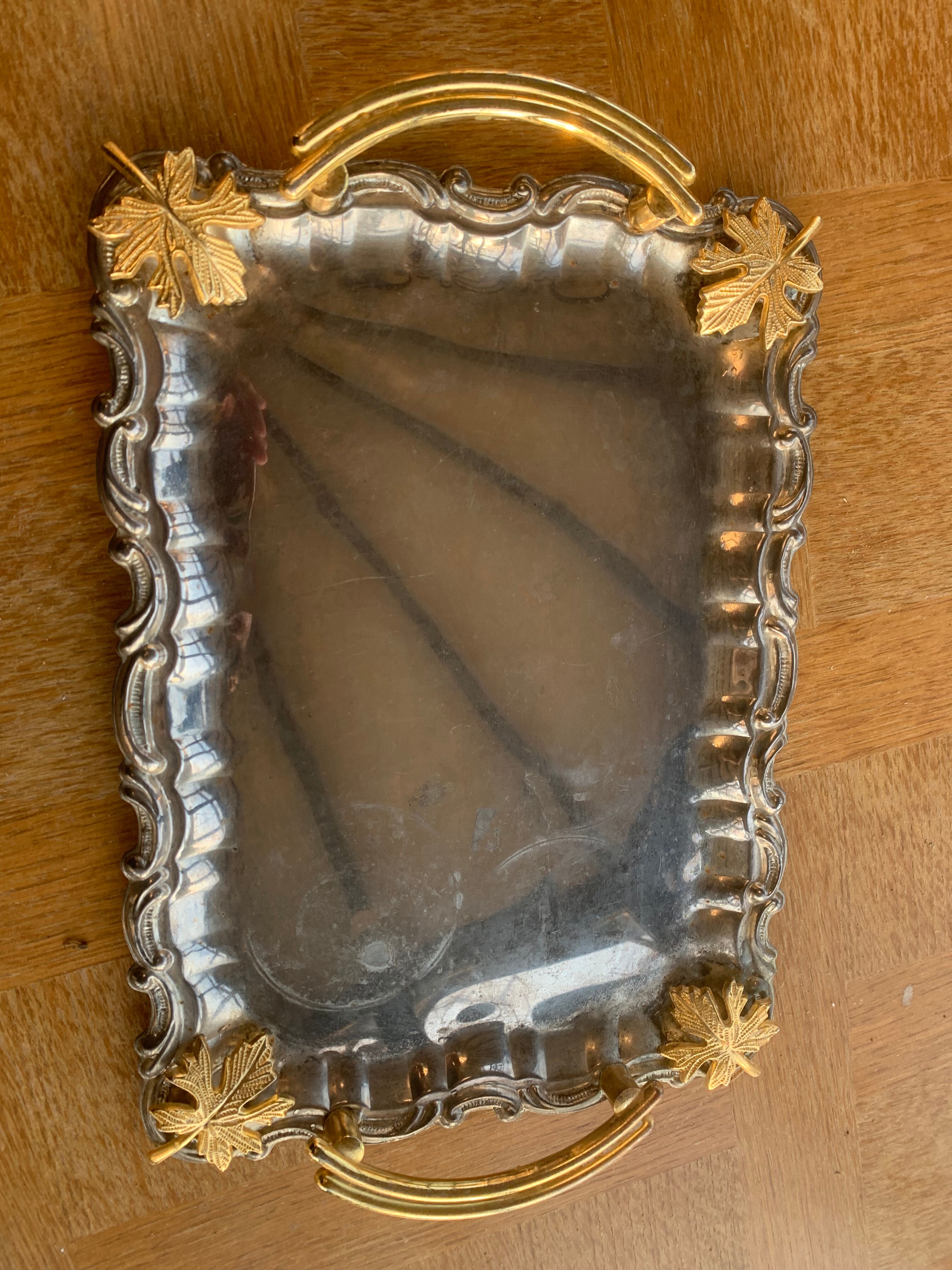 Silver metal top and decoration of foliage and handles in vintage brass