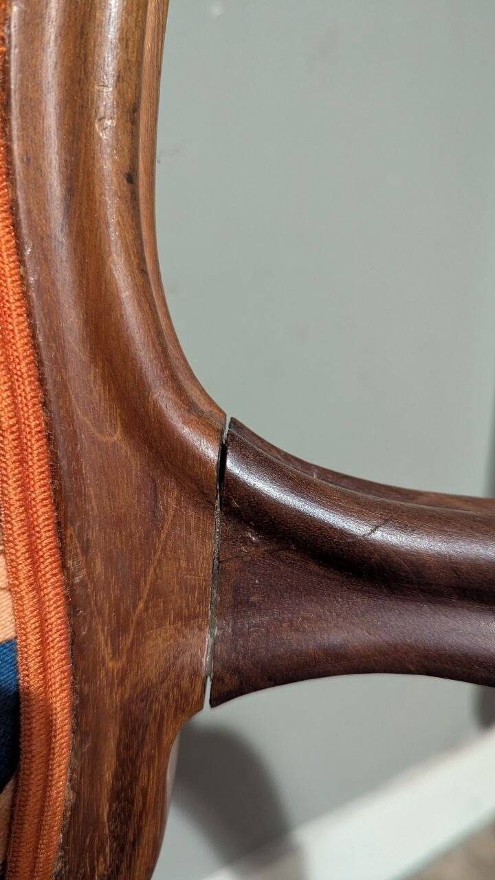 Restored Louis-Philippe cabriolet armchair, blue and orange floral fabric.