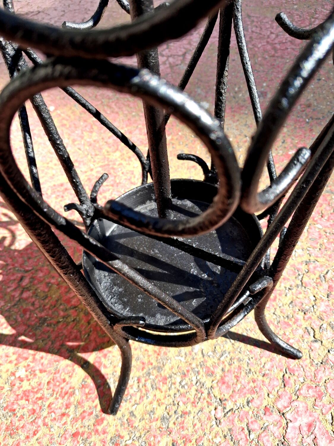 Antique wrought iron umbrella stand for entrance hall, vintage decor.