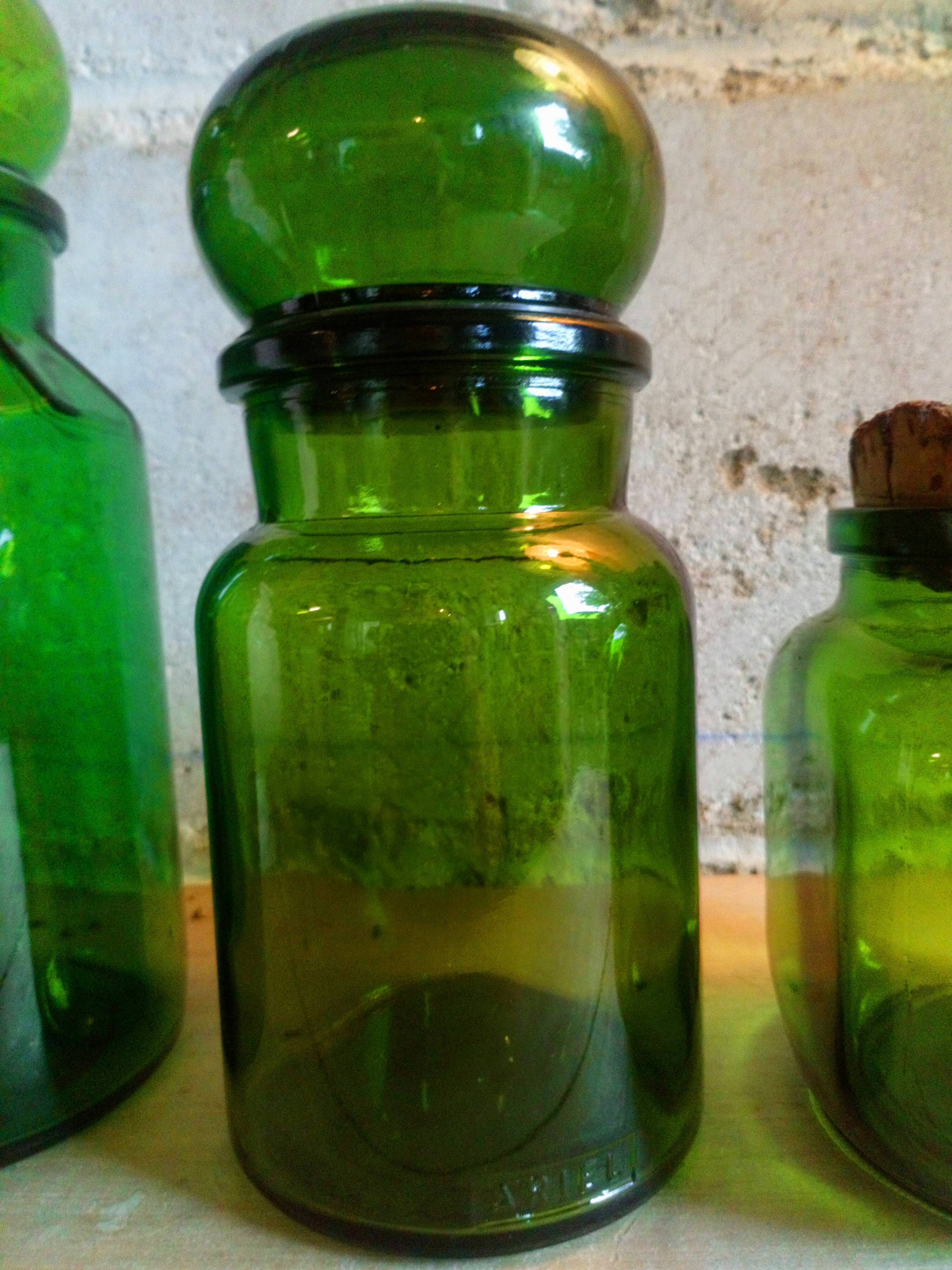 Trio of green glass apothecary bottles