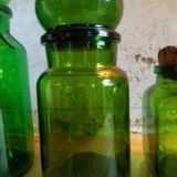 Trio of green glass apothecary bottles