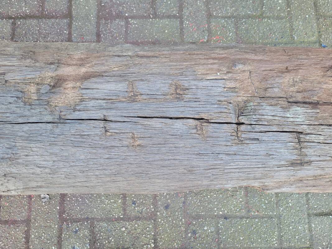 French country style cast iron bench with old rustic wooden plank