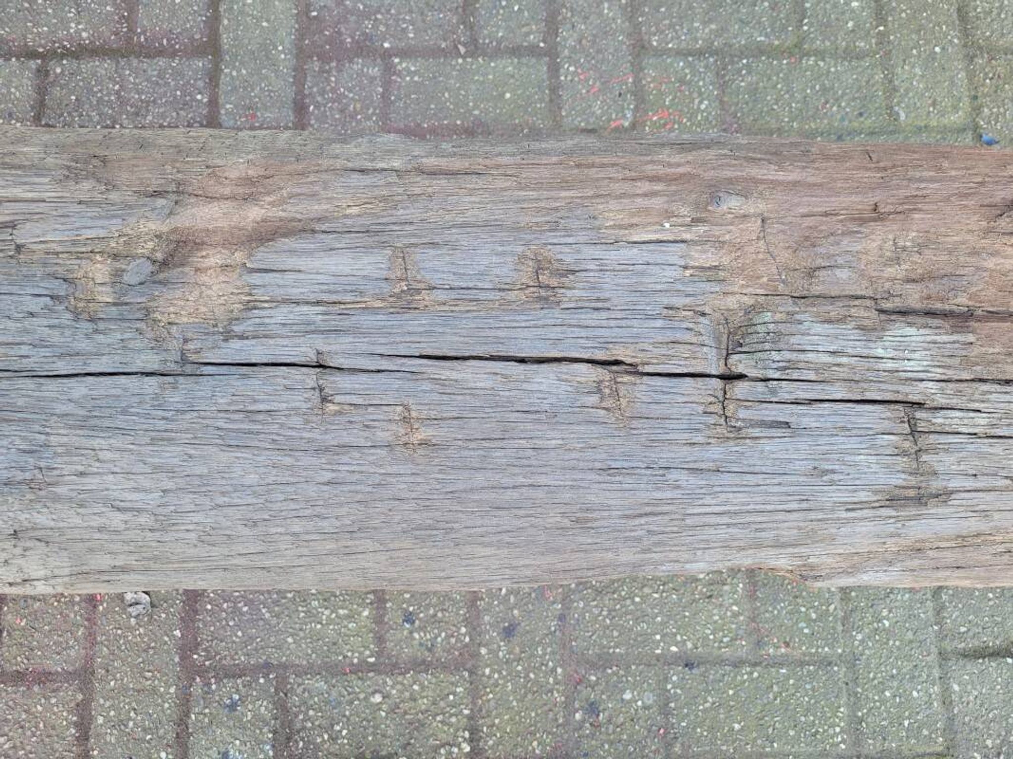 French country style cast iron bench with old rustic wooden plank