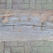 French country style cast iron bench with old rustic wooden plank
