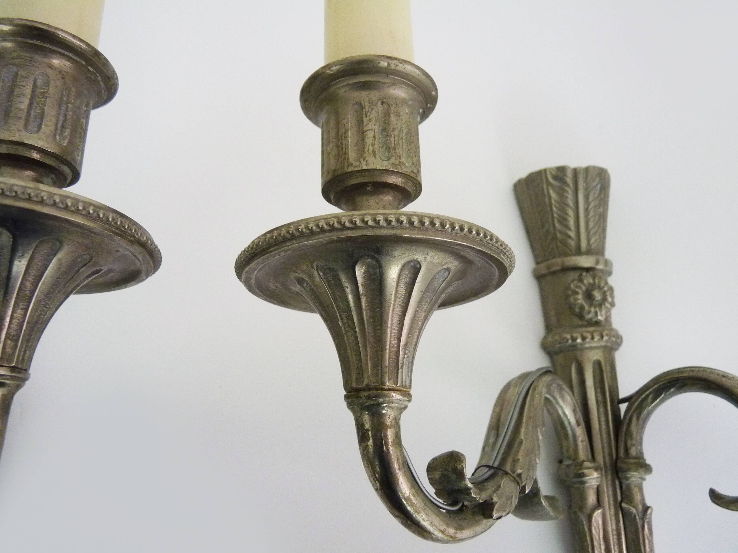 Pair of empire style double light wall lights in silvered bronze. the 50's
