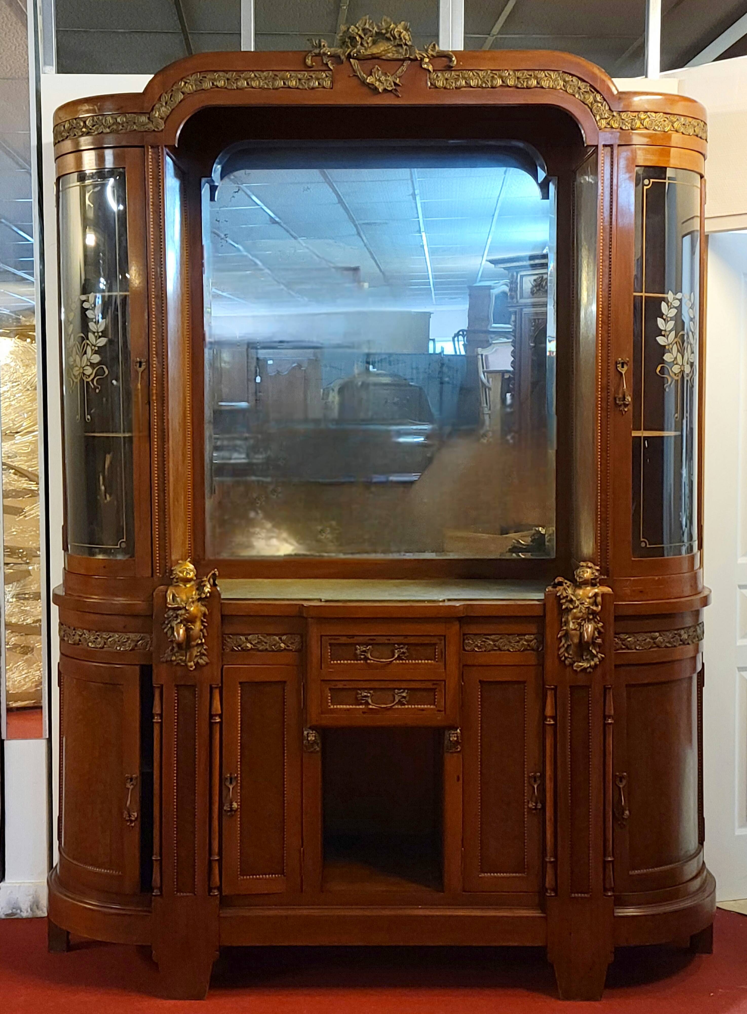 Empire style half-moon shaped mahogany bookcase with putti