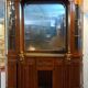 Empire style half-moon shaped mahogany bookcase with putti