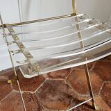 Folding chairs with gold metal structure and methacrylate slats seat and back.