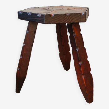 Tripod stool carved with a stylized plant motif
