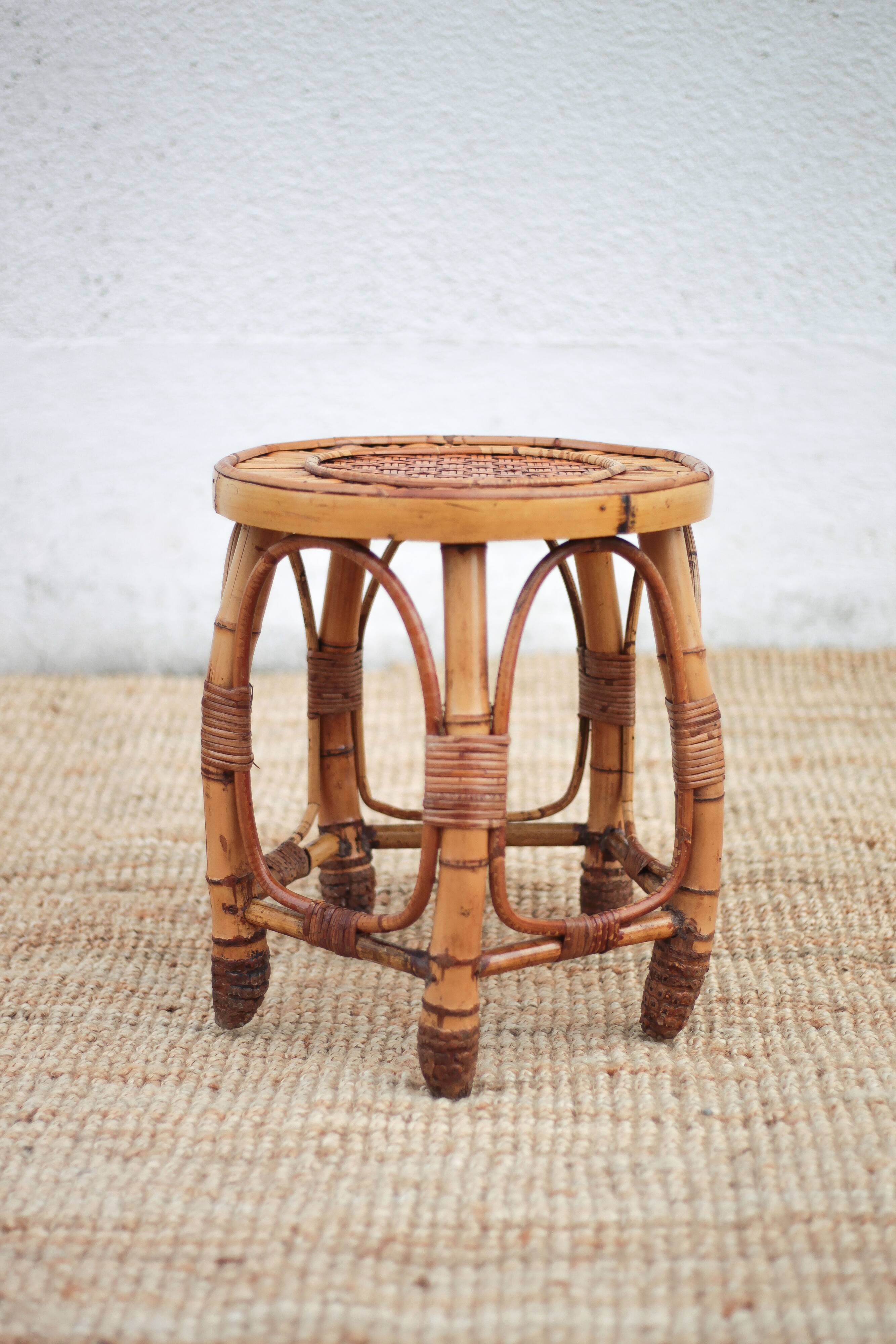 Vintage bamboo stool, woven rattan plant stand, interior decoration.