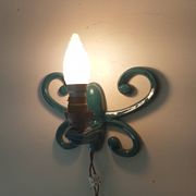 Antique wall light in enamelled cast iron.
