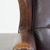 Wing chair made of sheepskin and neatly finished with black piping