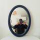 Vintage oval mirror in petrol blue wood