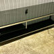Table basse design vintage chrome et verre fumé noir sur roulettes