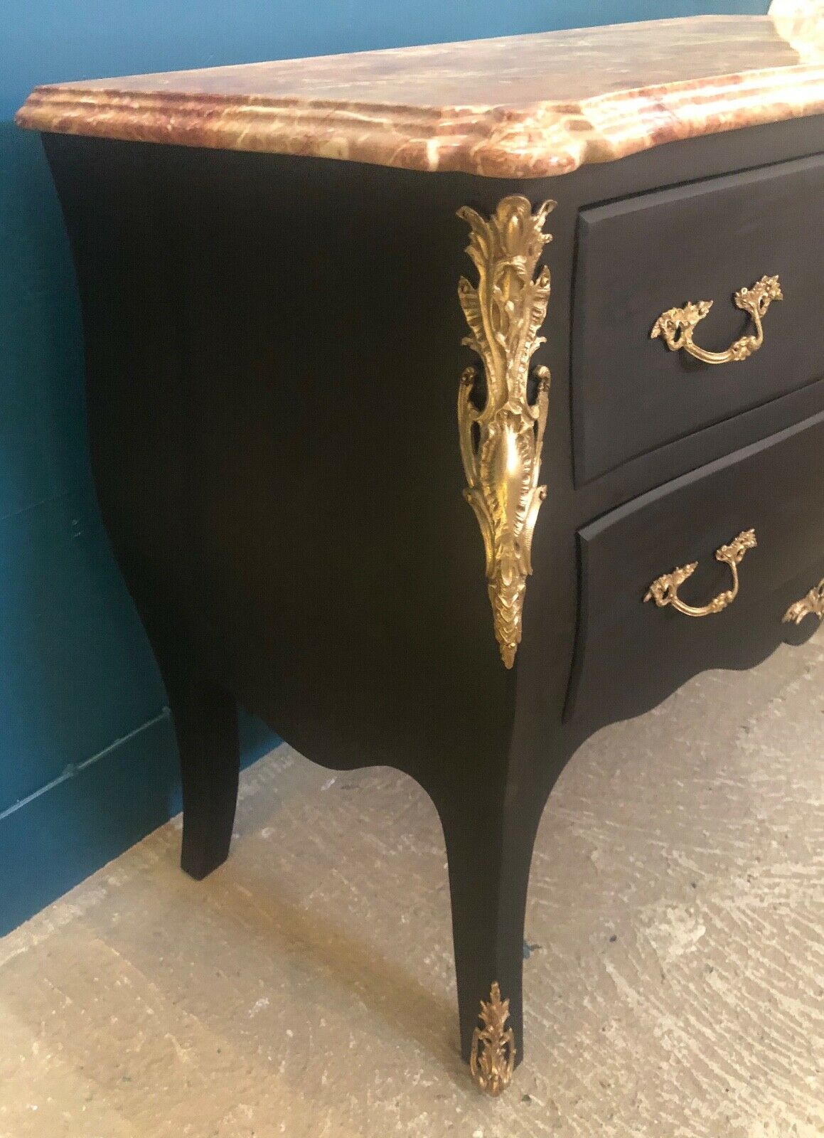 Louis XV style curved black matte commode with gilded bronze ornamentation from the 1950s.
