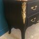 Louis XV style curved black matte commode with gilded bronze ornamentation from the 1950s.