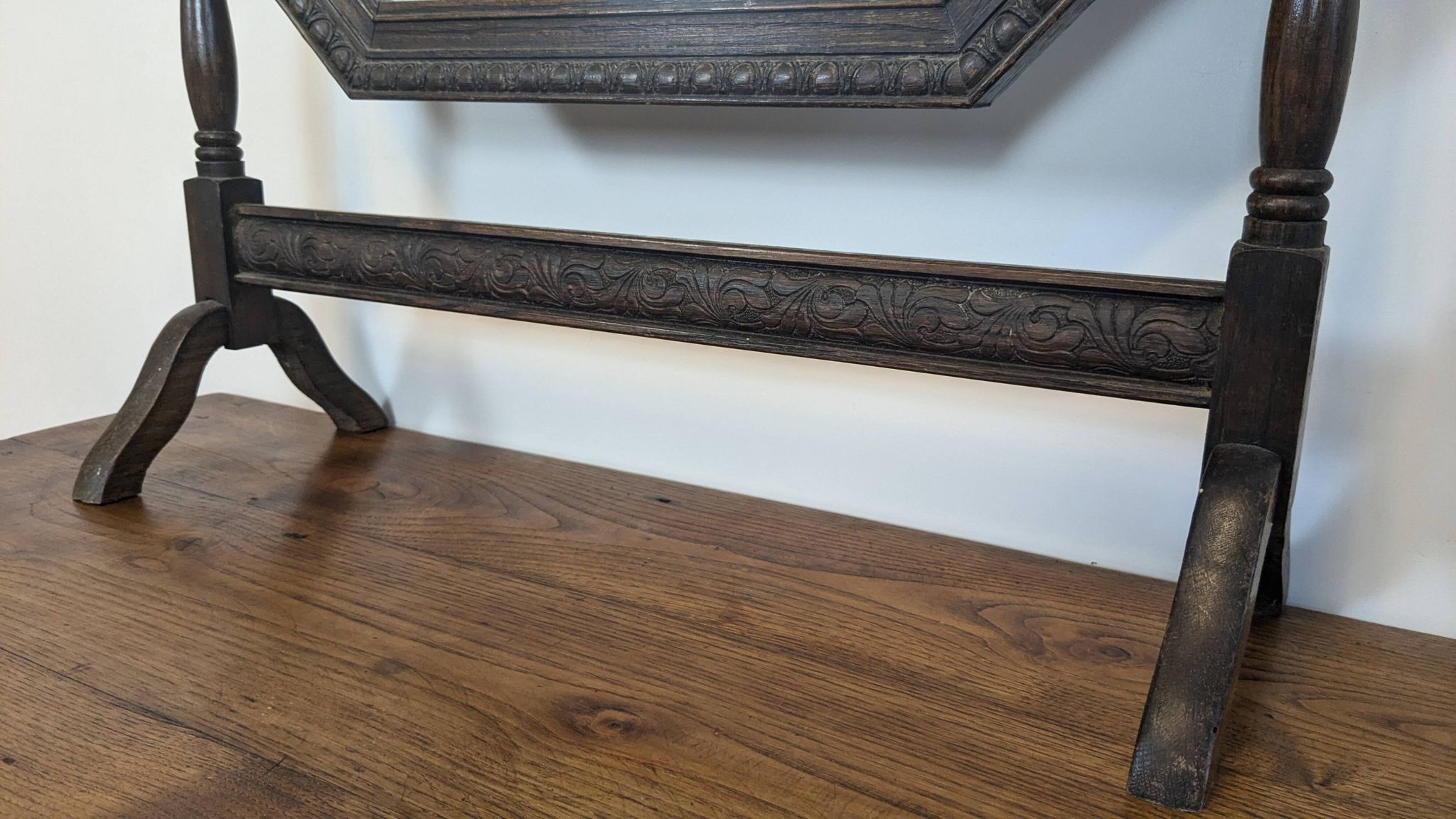Antique beveled octagonal vanity mirror in carved wood