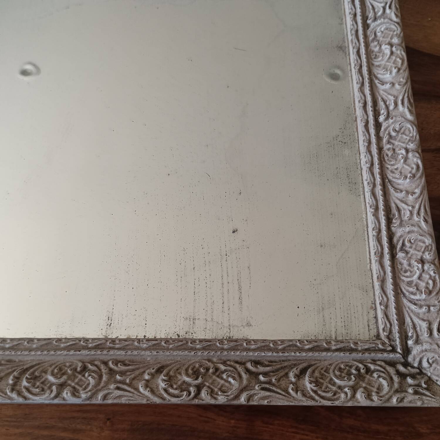 Antique mirror in carved, painted and patinated wood