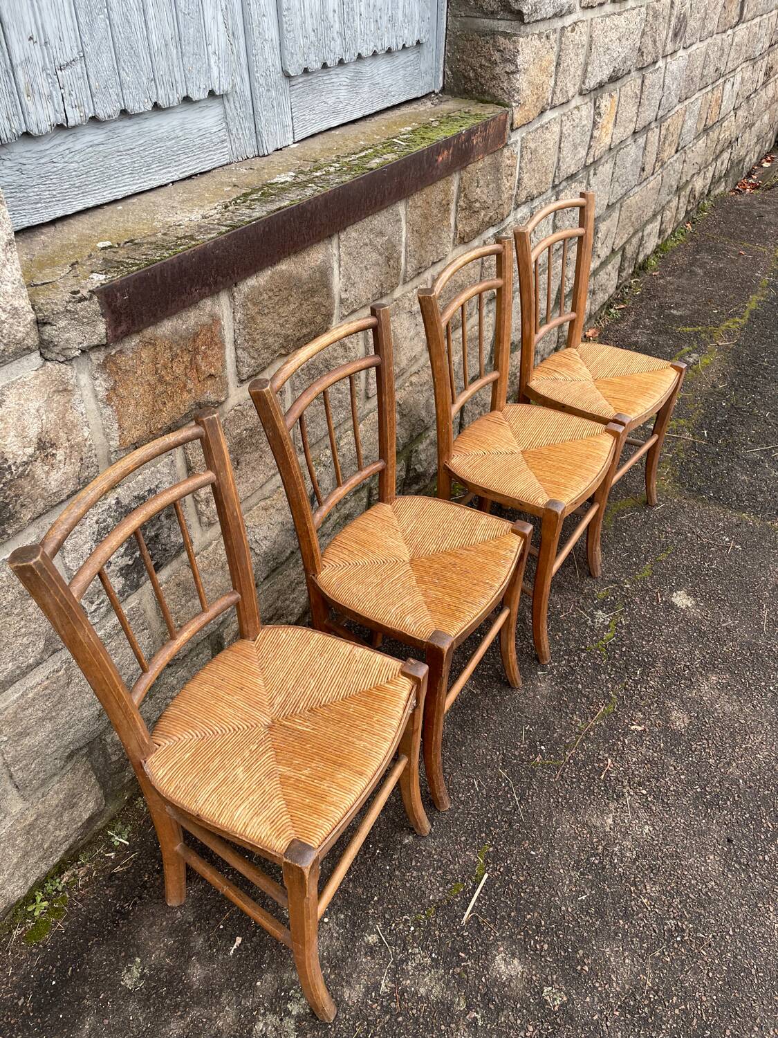 four vintage bistro-style straw chairs