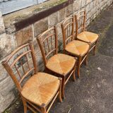 four vintage bistro-style straw chairs