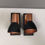 A pair of wall lamps from Eglo, in copper color and black.