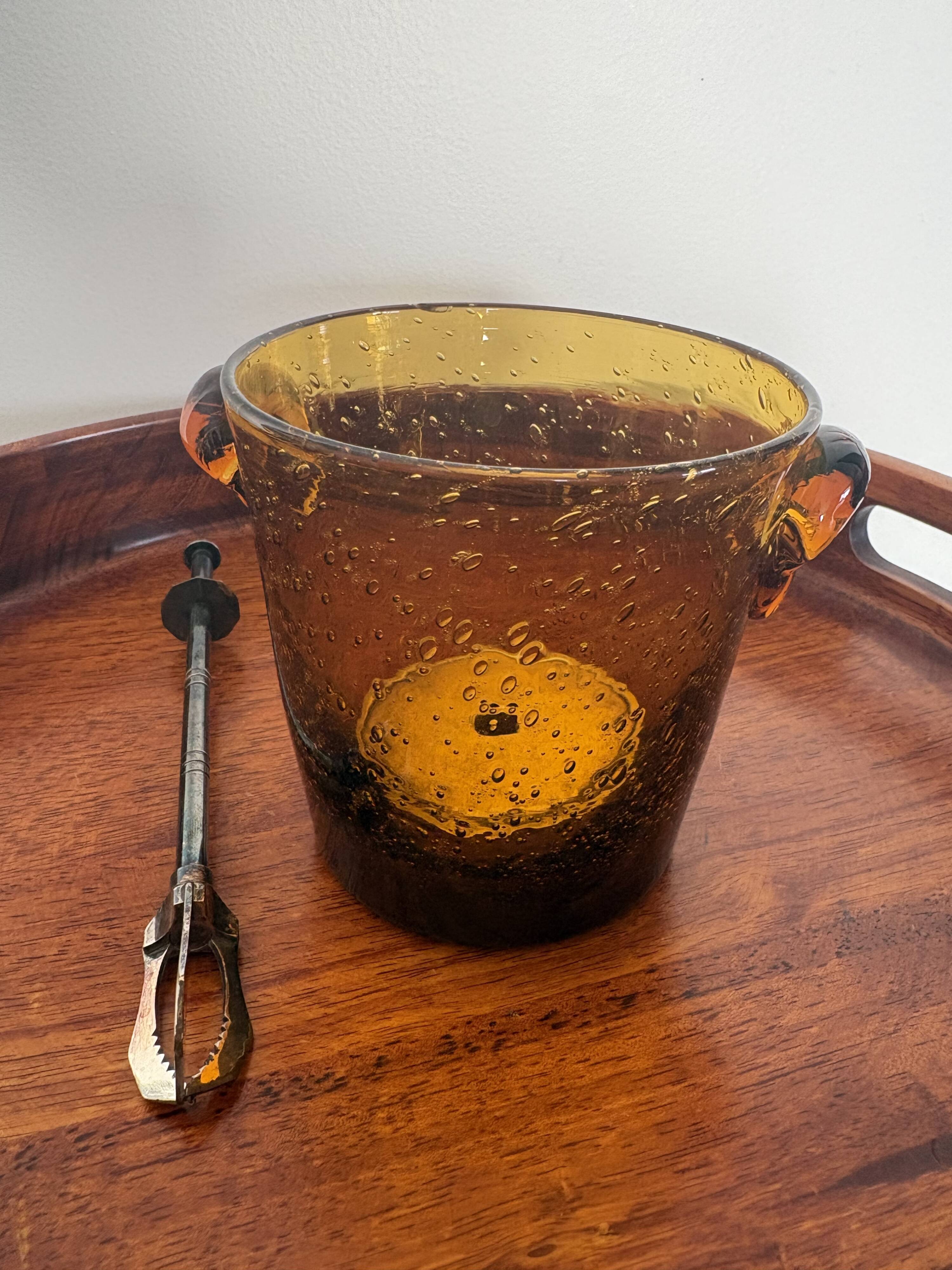 Amber bubble glass ice bucket signed Biot, with its tongs.