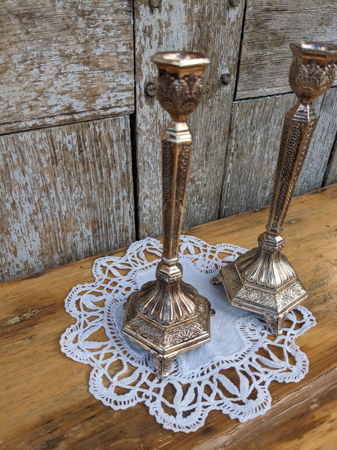 Pair of chiseled metal candle holders