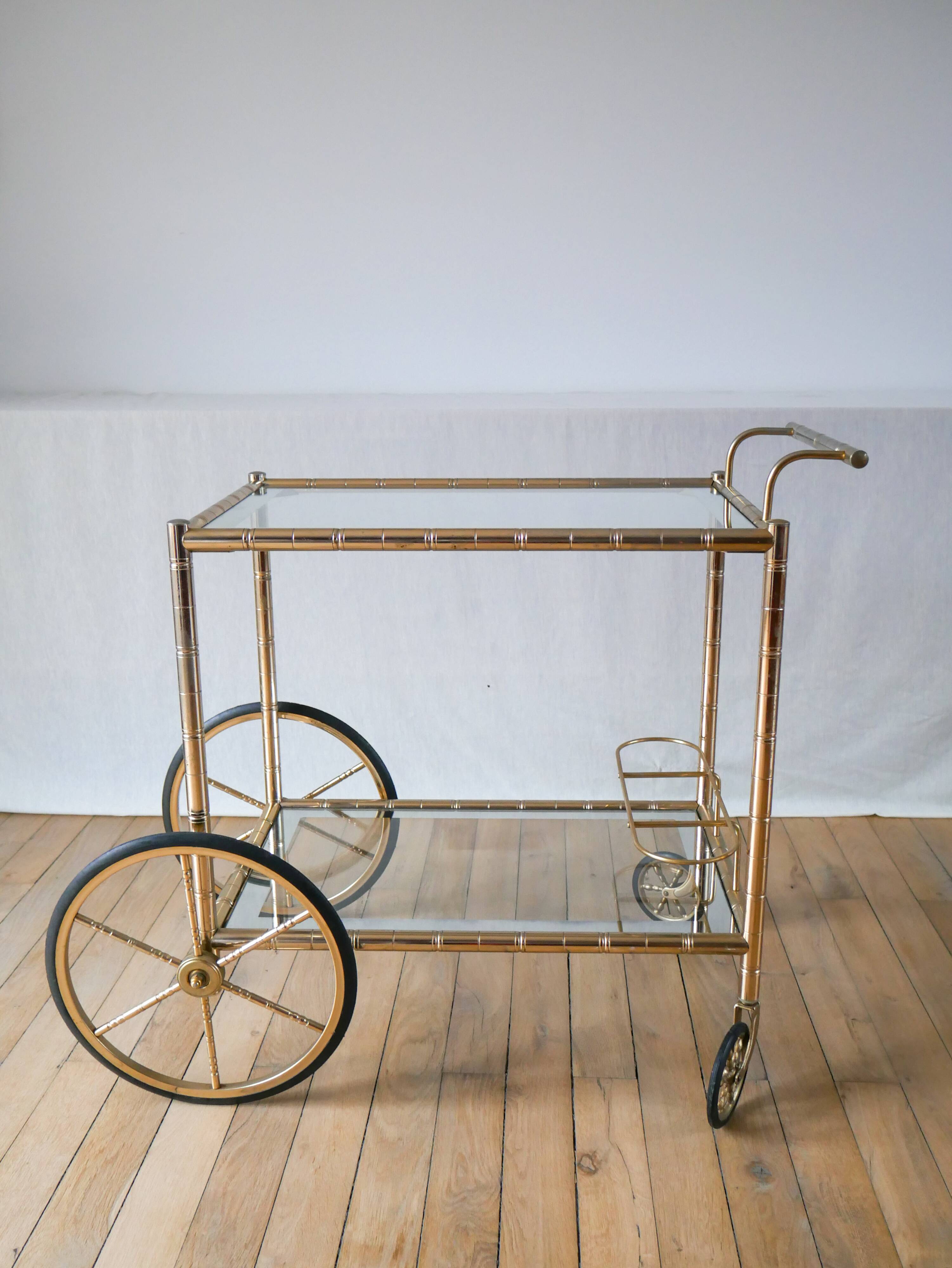 Serving table in gilded metal and glass with large wheels 1950