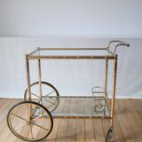 Serving table in gilded metal and glass with large wheels 1950