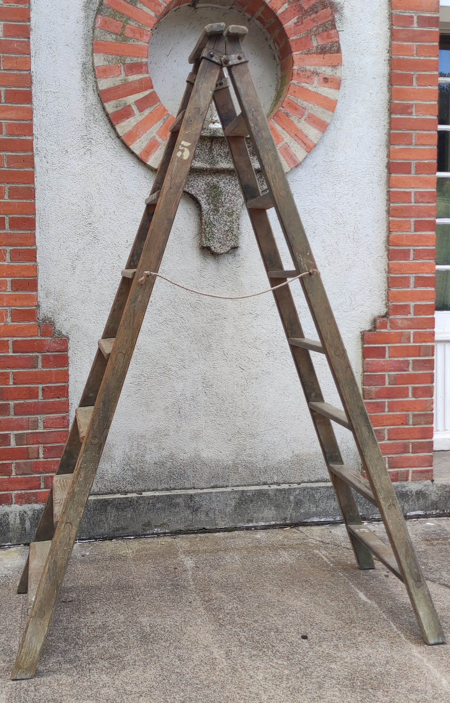 Old wooden stepladder stamped