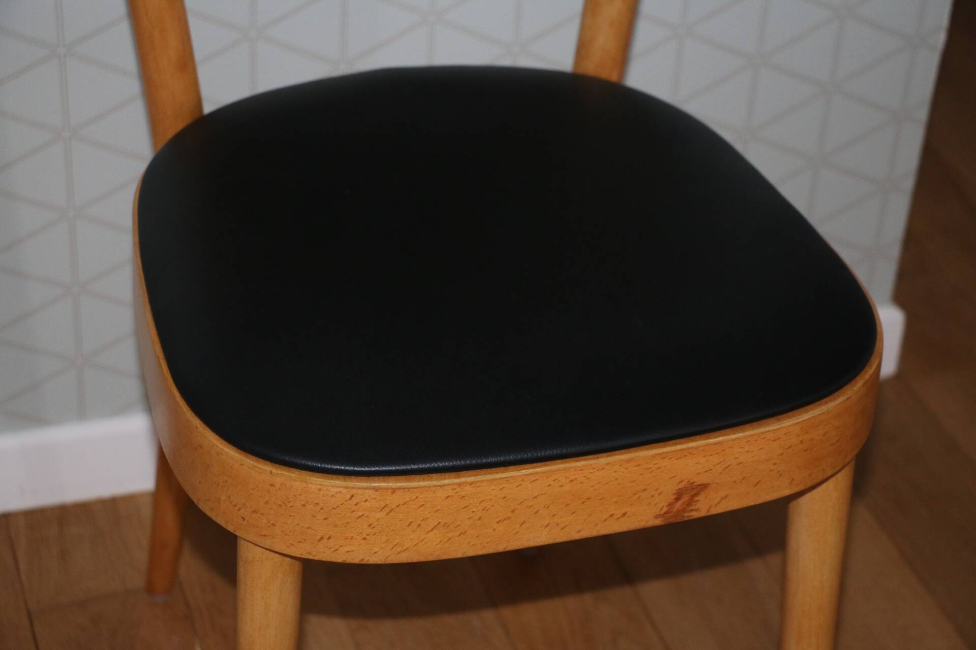 5 baumann chairs with large backs in black faux leather.