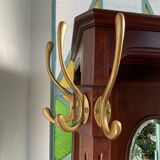 Antique wooden coat rack with mirror and shelf.