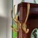 Antique wooden coat rack with mirror and shelf.