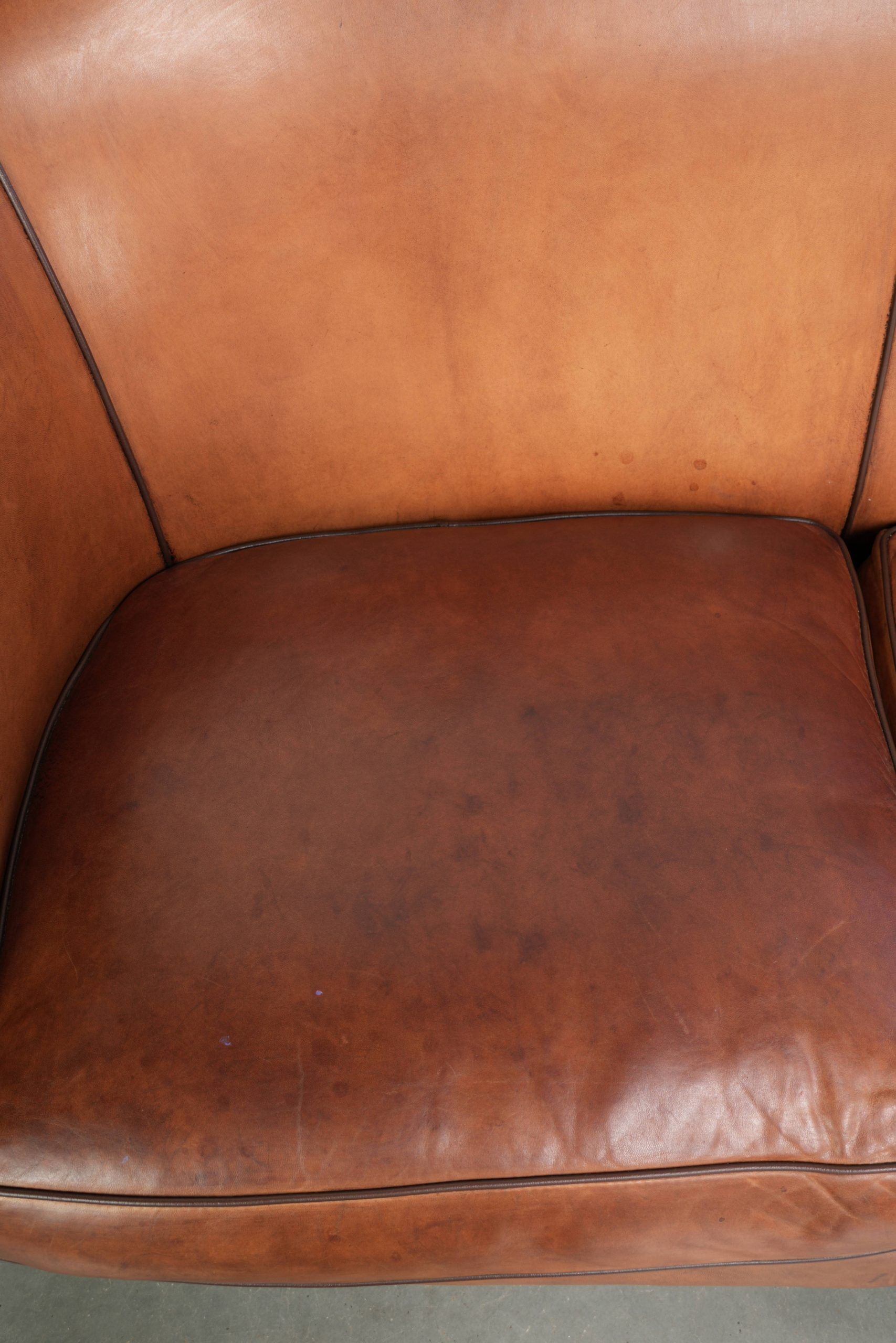 Sheepskin 2-seater sofa with a warm cognac brown colour scheme