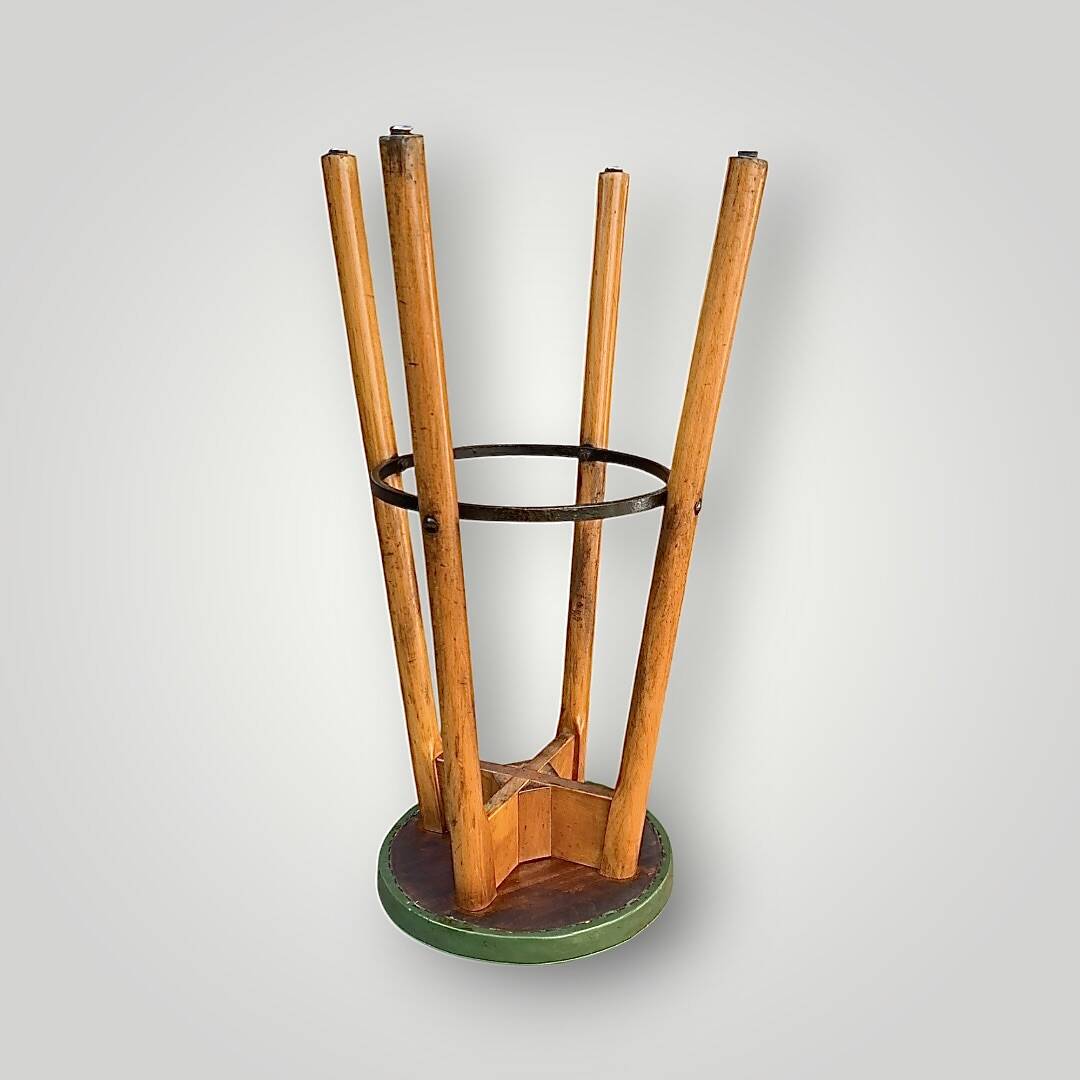 Old solid wood bar stool, metal footrest, green leatherette seat