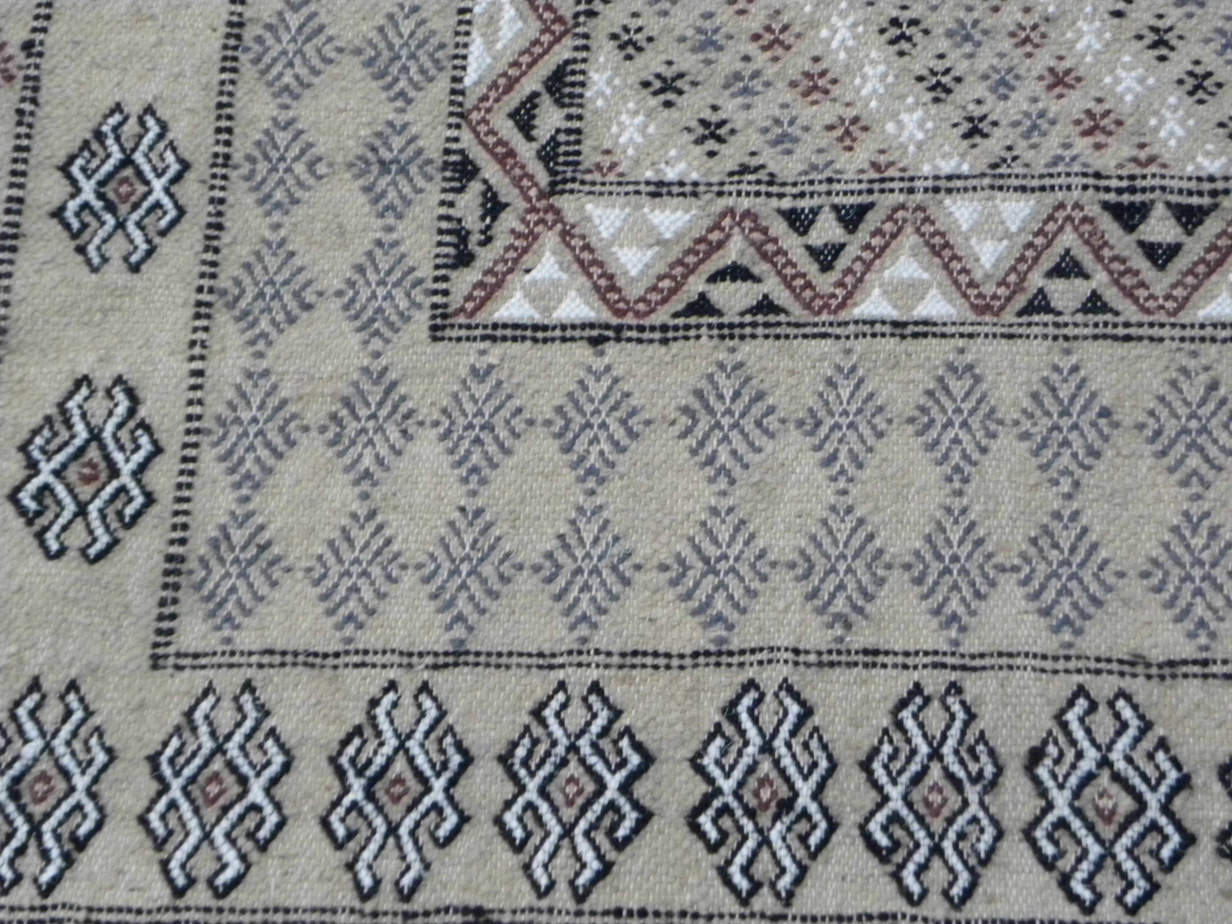 Traditional handmade Berber carpet in brown and beige wool.