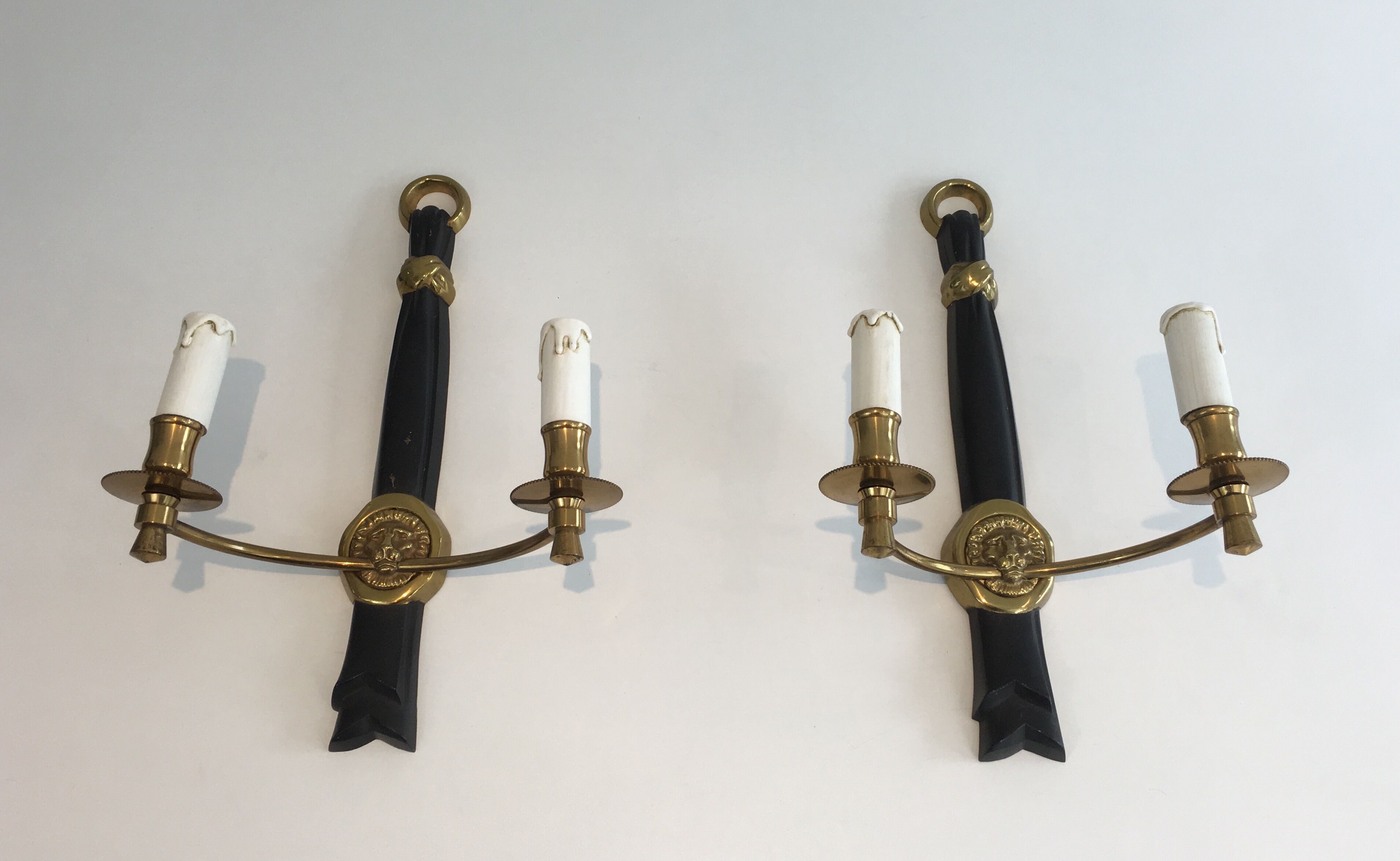 Pair of Black Lacquered Bronze Wall Lamps with Lions' Head Decorations. Around 1970