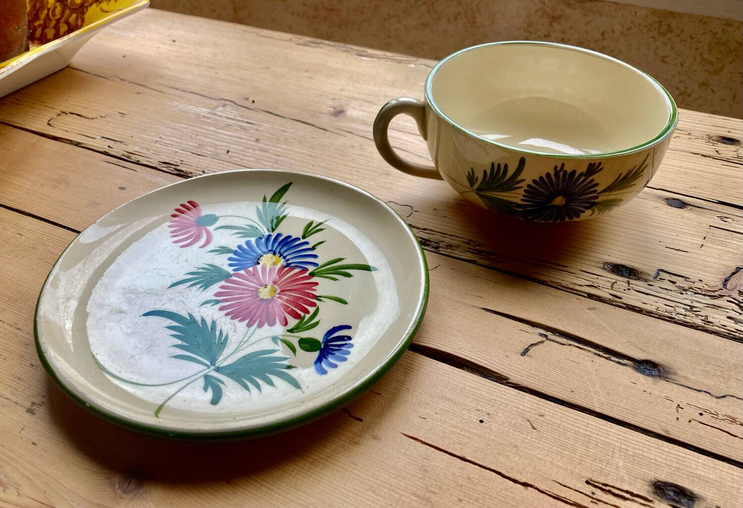 Large cup and saucer in the quimper earthenware style.
