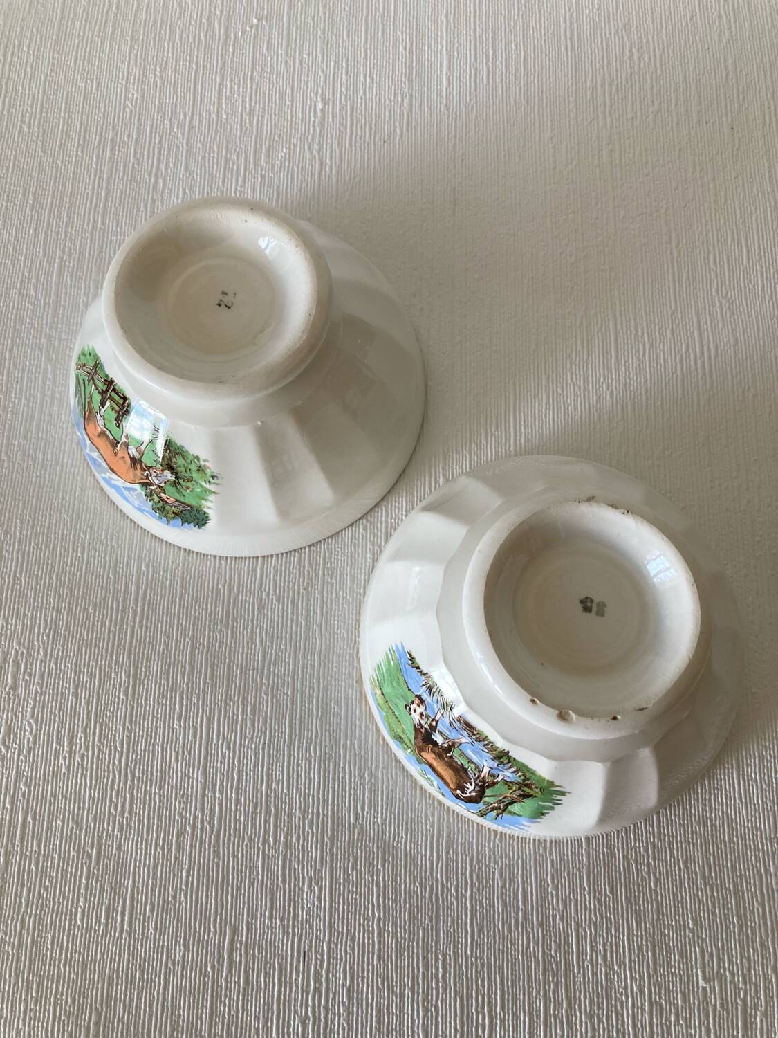 Pair of small faceted bowls with cow illustrations from the 40s and 50s
