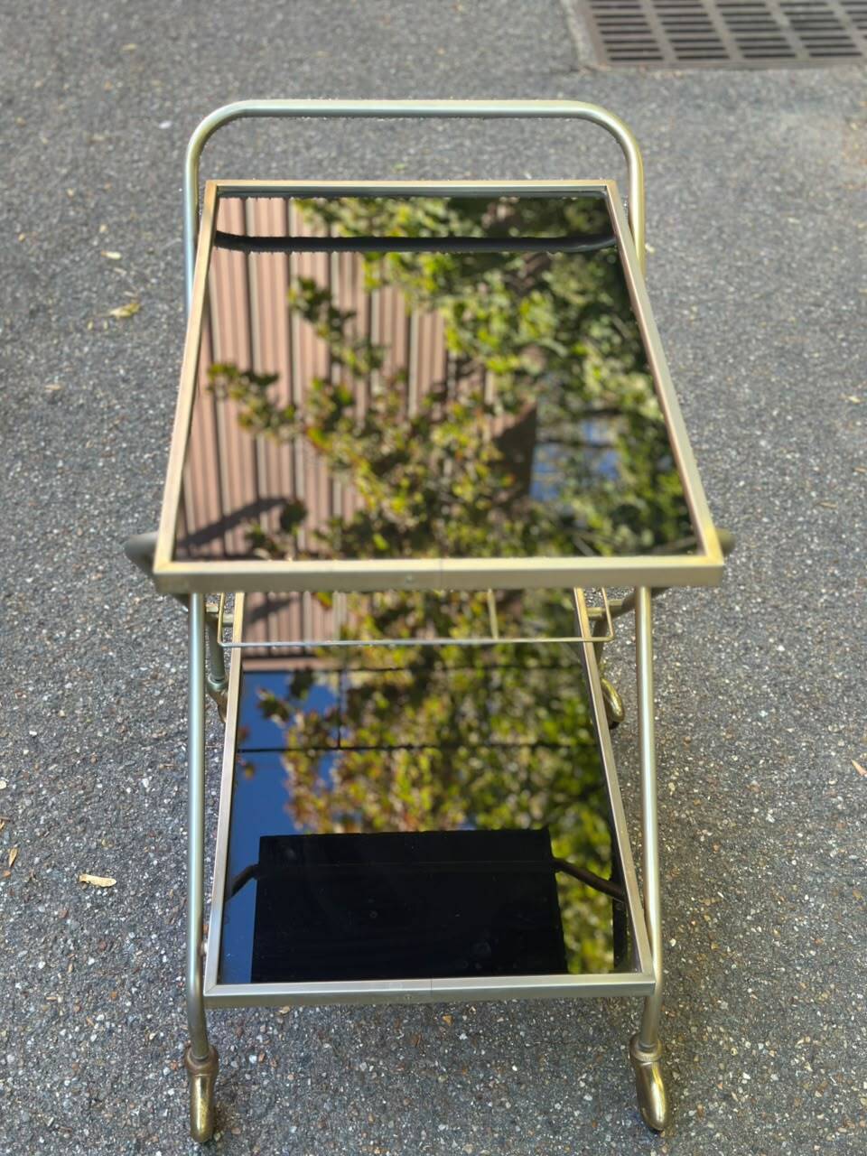 Mid-Century 1978 brass and black smoked glass wheeled dessert trolley.