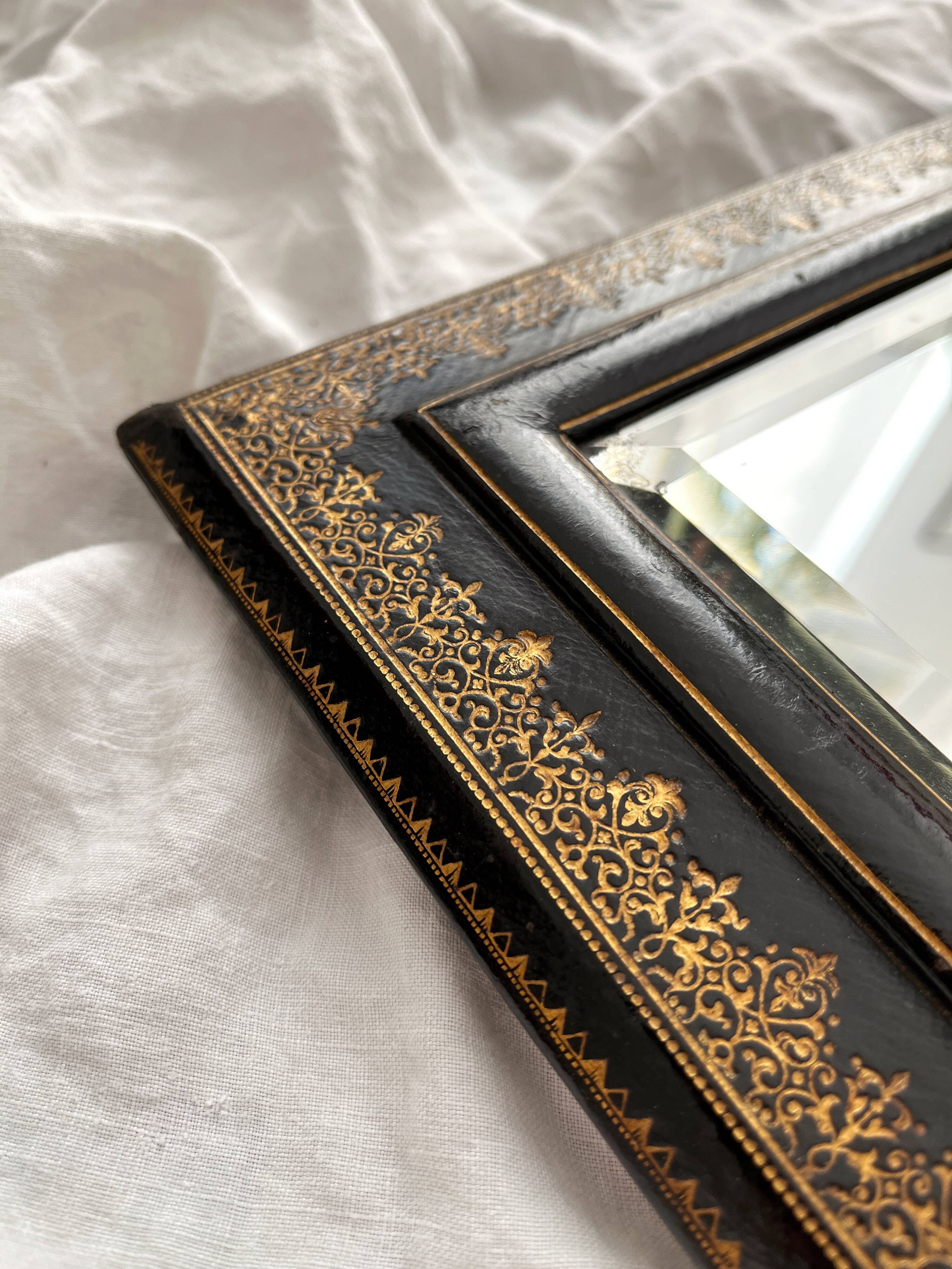 Old beveled mirror with black and gold leather binding Napoleon III