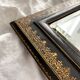 Old beveled mirror with black and gold leather binding Napoleon III