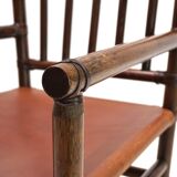 Manou rattan armchair with leather seat, 1960