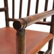 Fauteuil Manou en rotin et assise en cuir, 1960