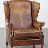 Charming sheep leather wingback armchair with a beautiful patina and excellent seating comfort