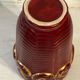 Mid-century relief vase in ruby red enhanced with gilding.